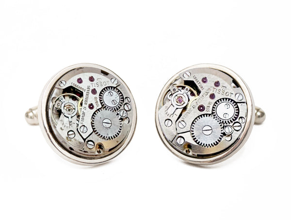 Image displaying a pair of circular Tissot watch movement cufflinks with no crowns.