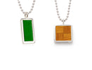 two pendants on silver chains. left is green parquet floor, right is patterned natural parquet floor.