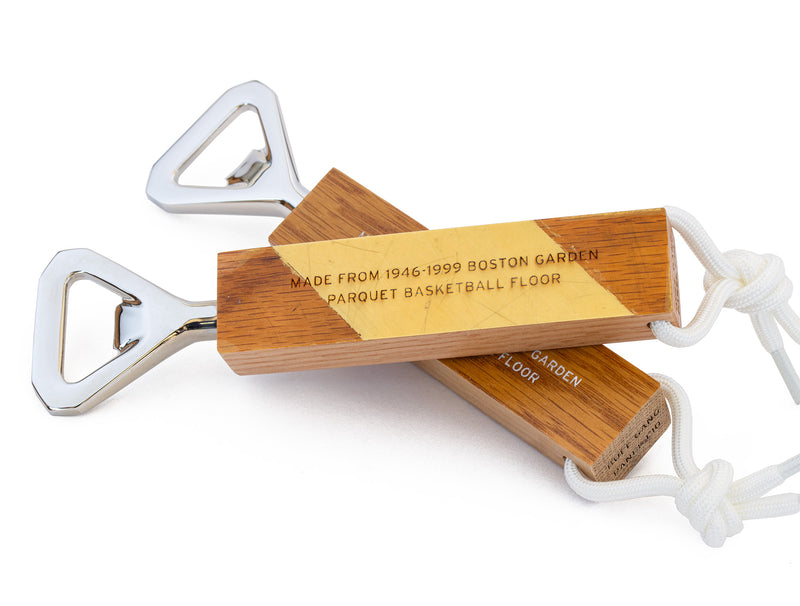 image displaying two boston garden parquet floor bottle openers crossing one another.