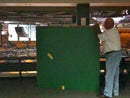 image displaying bob rutko, head of sports memorabilia at td garden, holding a green parquet panel.