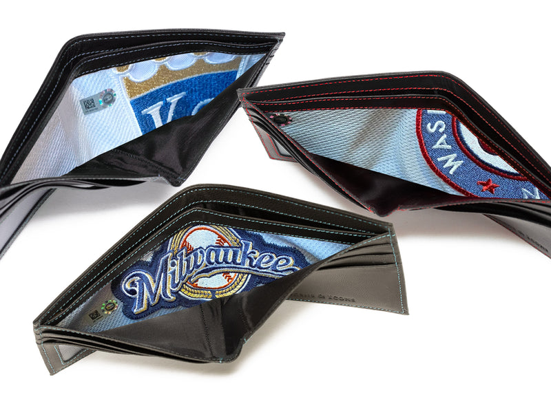 image displaying three open leather billfold wallets with uniform emblem panels on display.