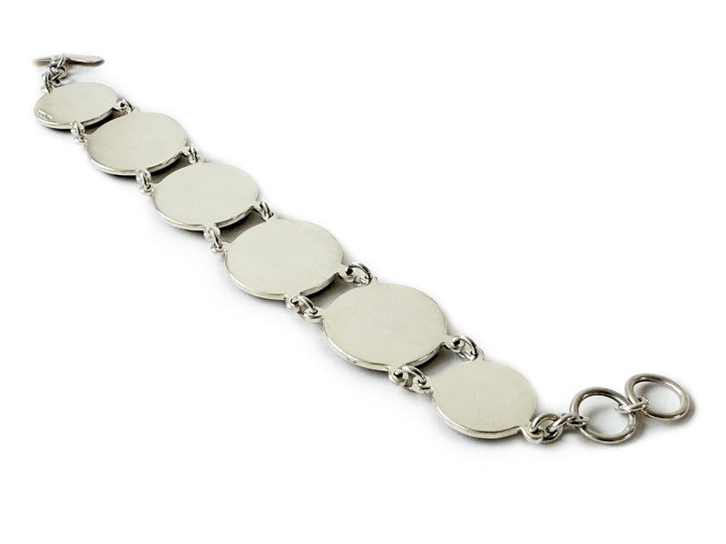 image displaying the sterling silver bezel backside of the 5 new york transit token bracelet.