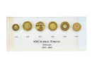 image displaying six vintage new york transit tokens with dates set in clear lucite. front view.