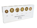 image displaying six vintage new york transit tokens with dates set in clear lucite.
