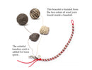 image displaying how the yarn bracelet is made. this bracelet is braided from the two colors of wool yarn found inside a baseball. the colorful bamboo cord is added for team spirit.