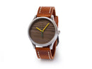 image displaying a watch with a brown leather watch strap and a watch face made from lambeau field wooden bench seat with yellow minute and hour hands and a dark green second hand.