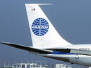 image displaying pan am n880pa 707 tail fin at an airport.