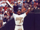image displaying ricky henderson from the oakland a's holding up a base in celebration.